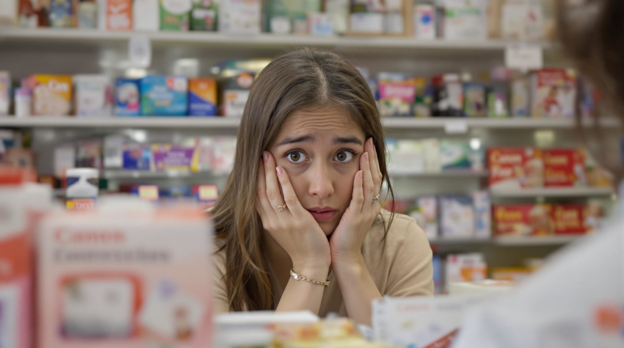 Worried woman at pharmacy counter
